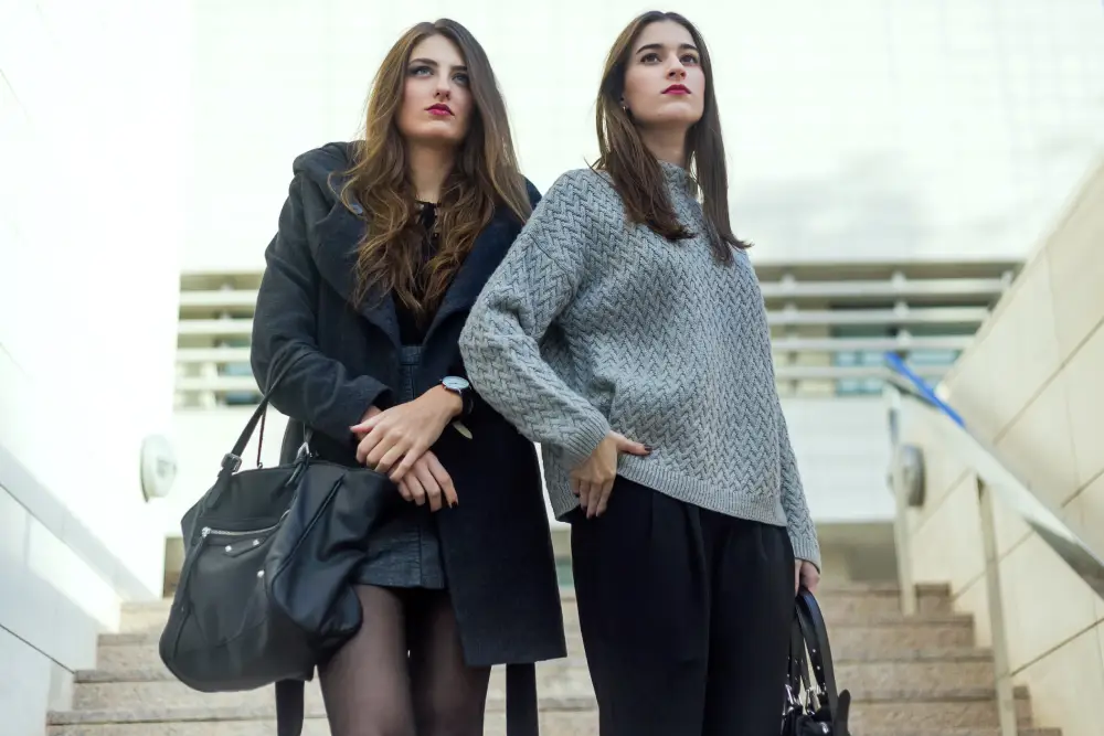 Young women posing on the street in fashionable outfits