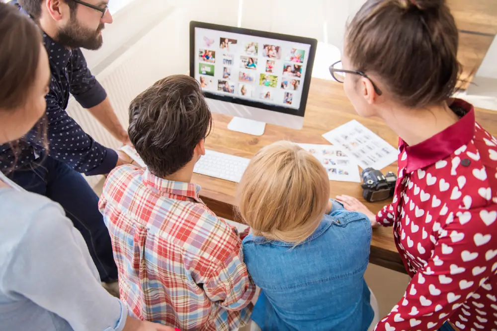Colleagues working together around a computer