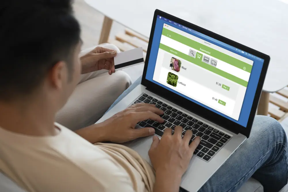 Couple shopping online on a laptop at home