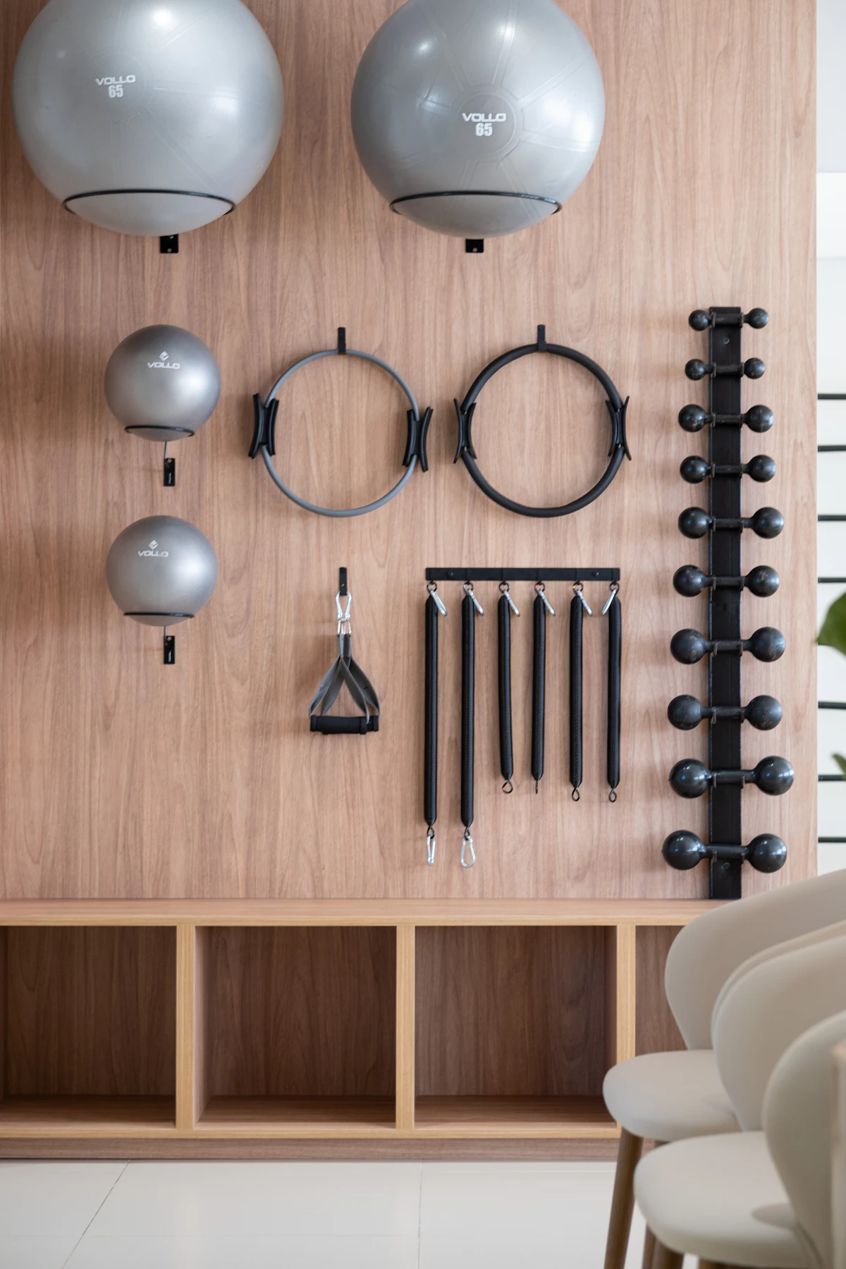 Gym equipment organised on a wooden wall, like a well-structured product collection