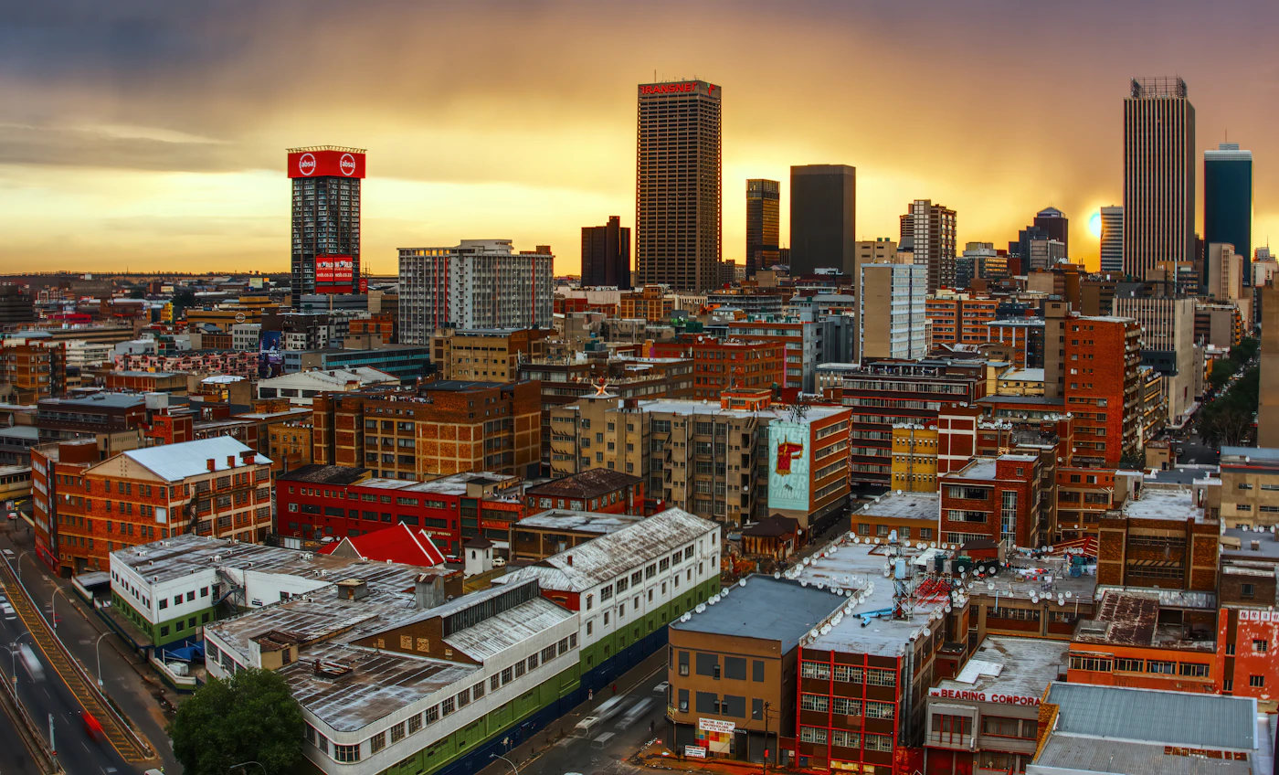 Johannesburg skyline under a warm golden sky