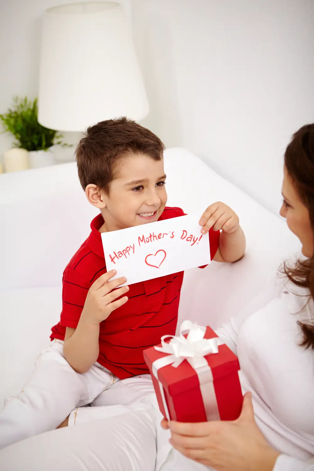 Little boy reading a letter with his mother