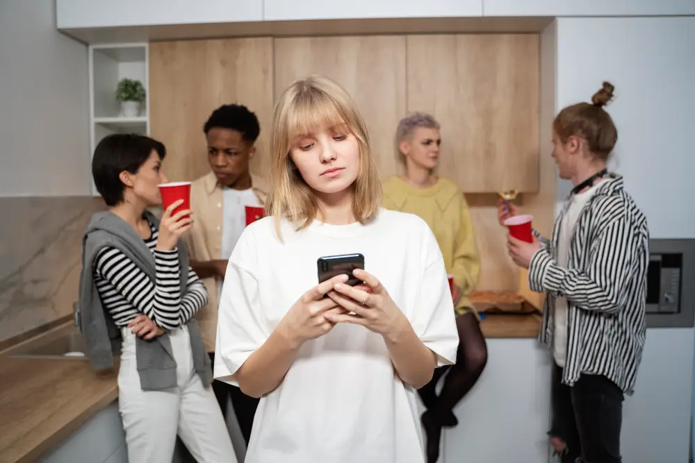 Woman sitting alone at a party, representing a Shopify store struggling to be found online