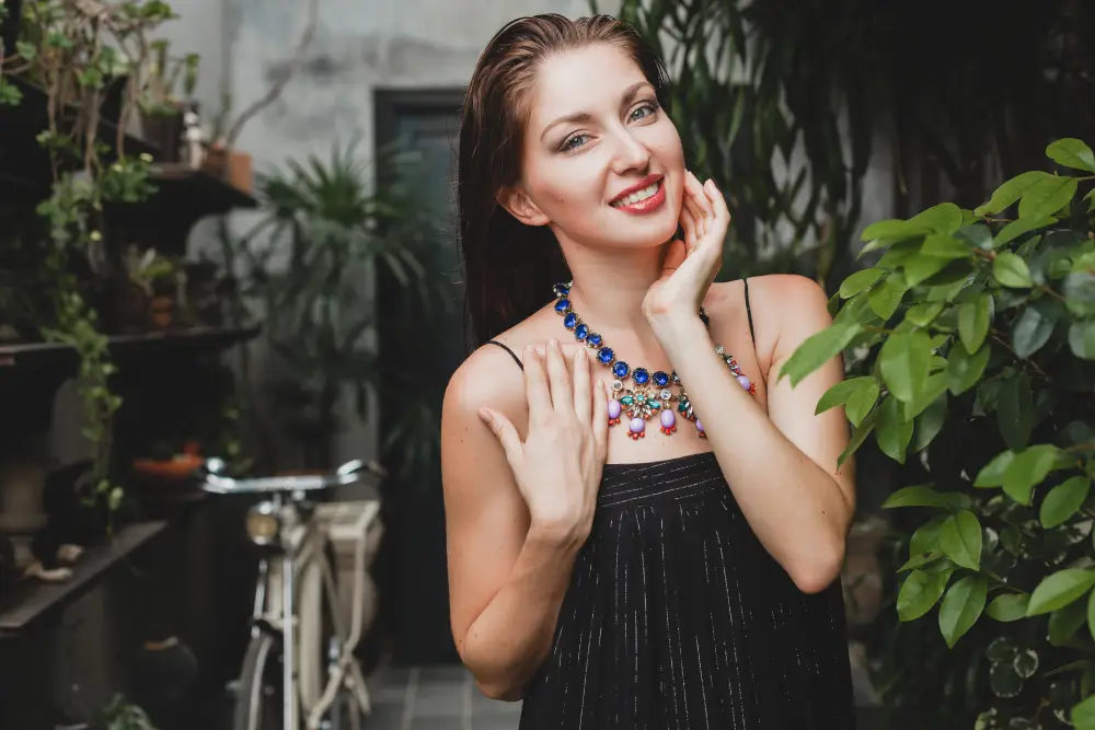 Woman in a stylish black dress wearing jewelry