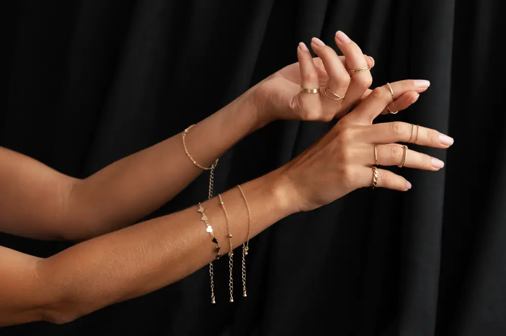 Woman's arms wearing gold jewelry